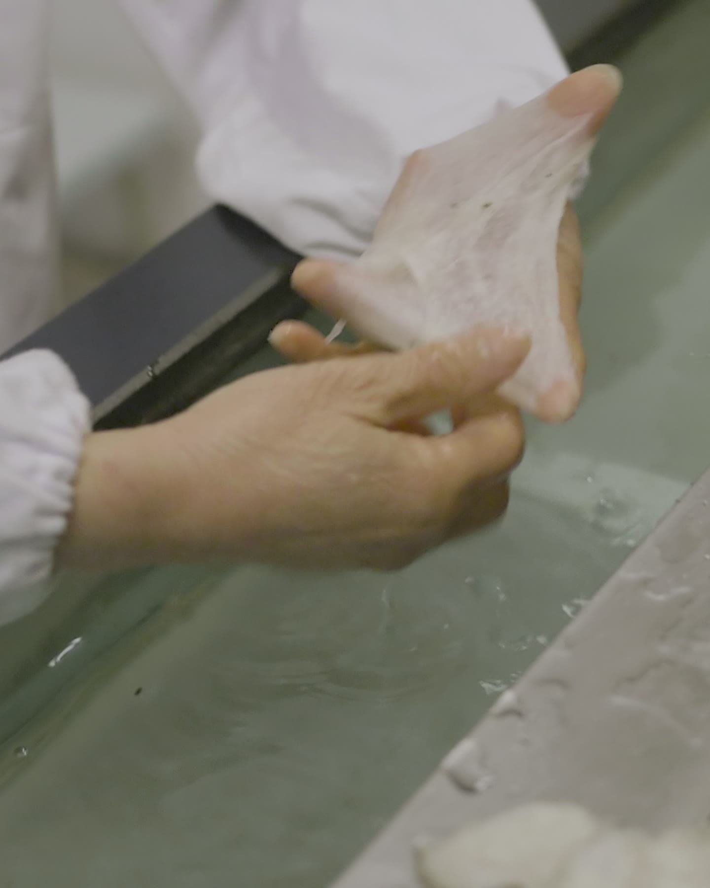 Floss drawn from water by hand